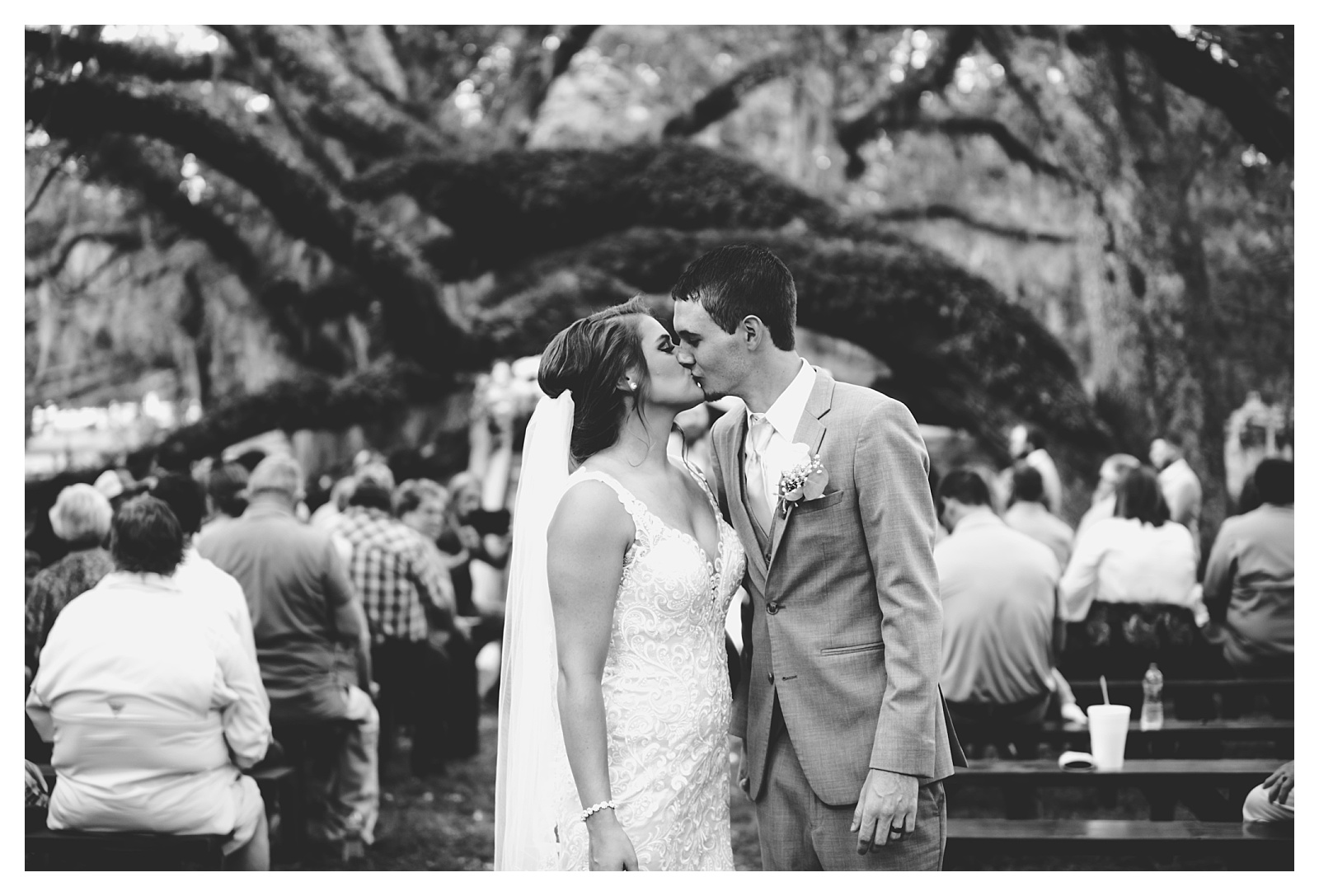 Black and white ceremony picture of bride and groom. Shelly Williams Photography