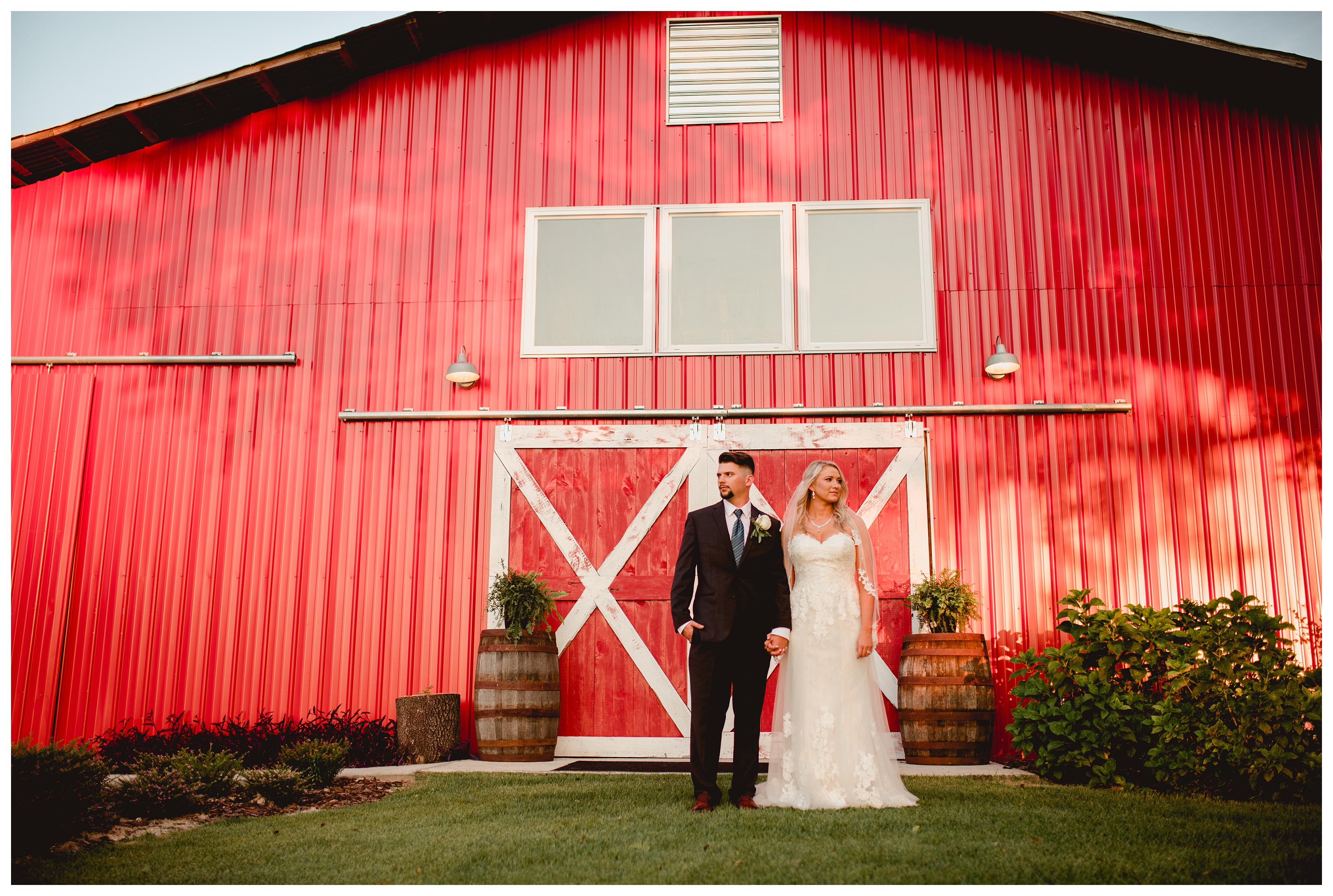 Bride and groom with red barn at Seven Hills Farm in Trenton. Pro wedding photographer in Tallahassee FL. Shelly Williams Photography